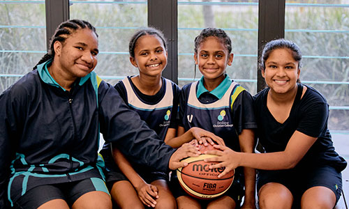 Young female basketball players holding a basketball
