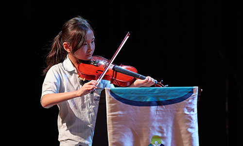 Female student showing her violin skills at the Instrumental Concert