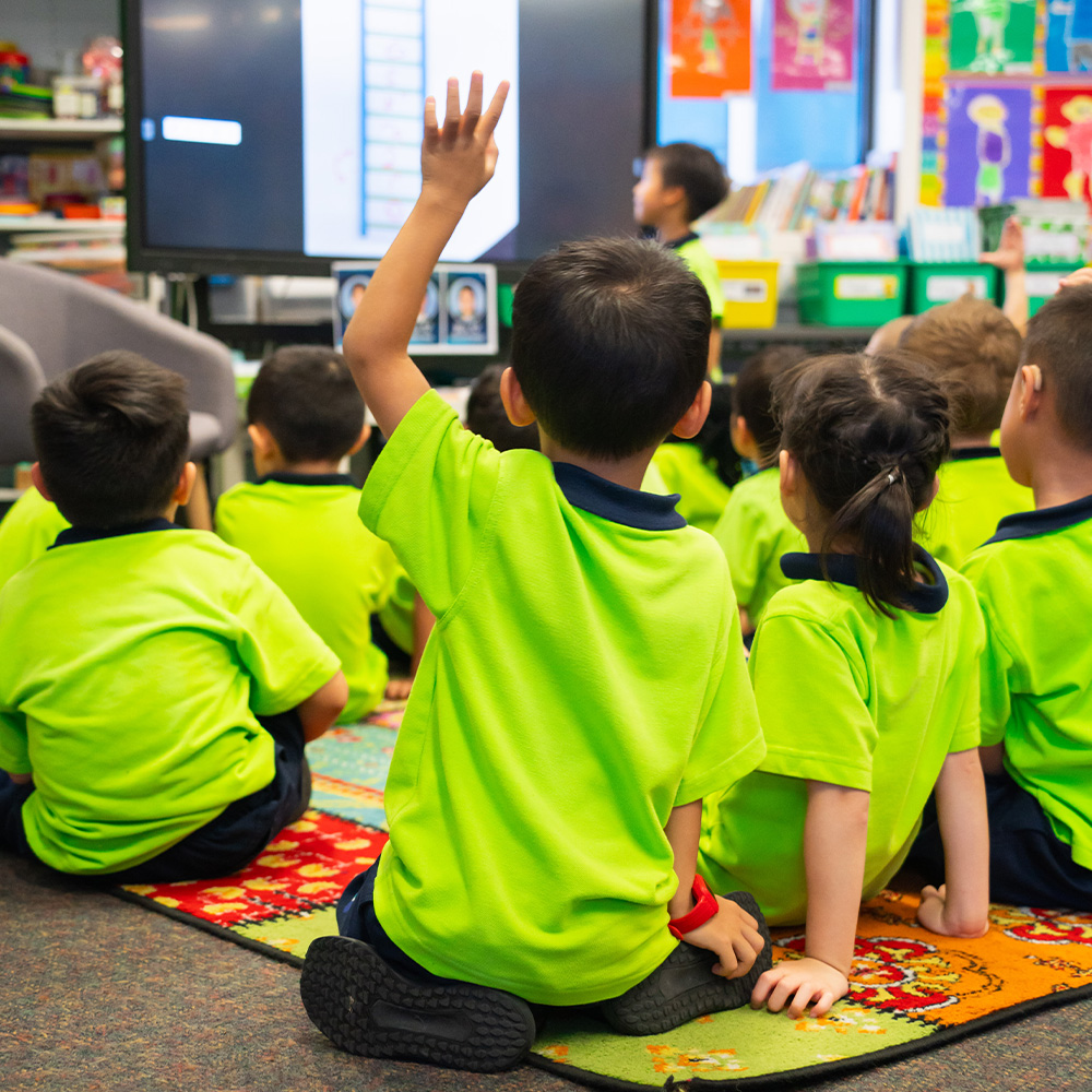 Male students looking at the school magazine