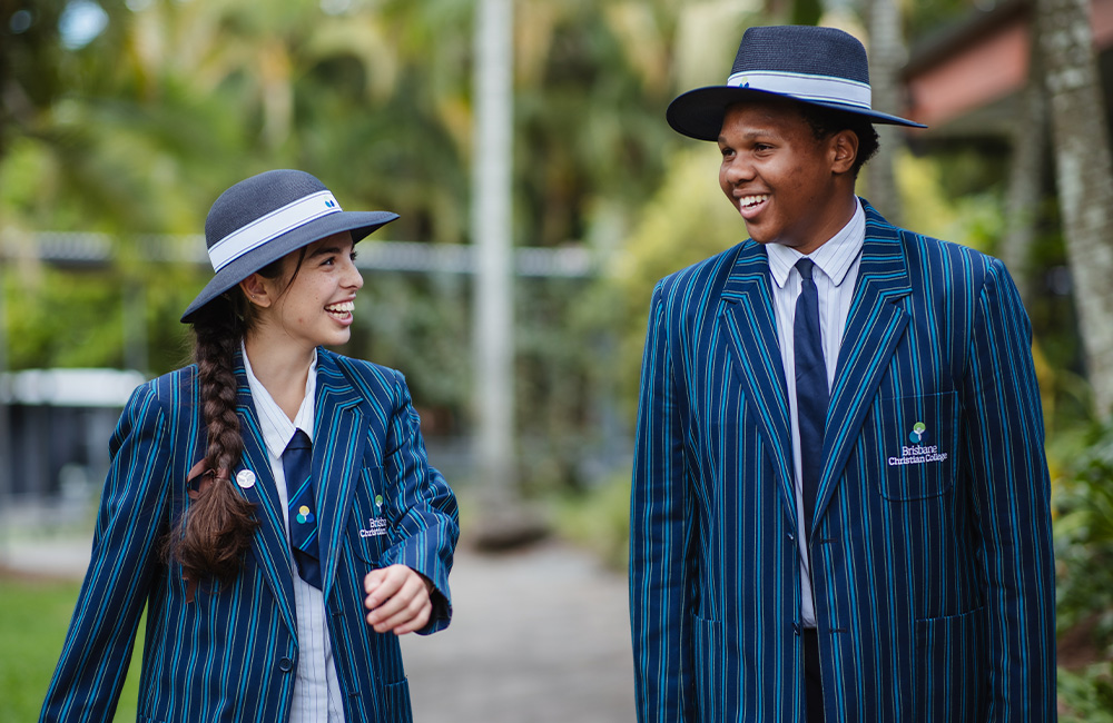 Three lovely secondary students smiling brightly
