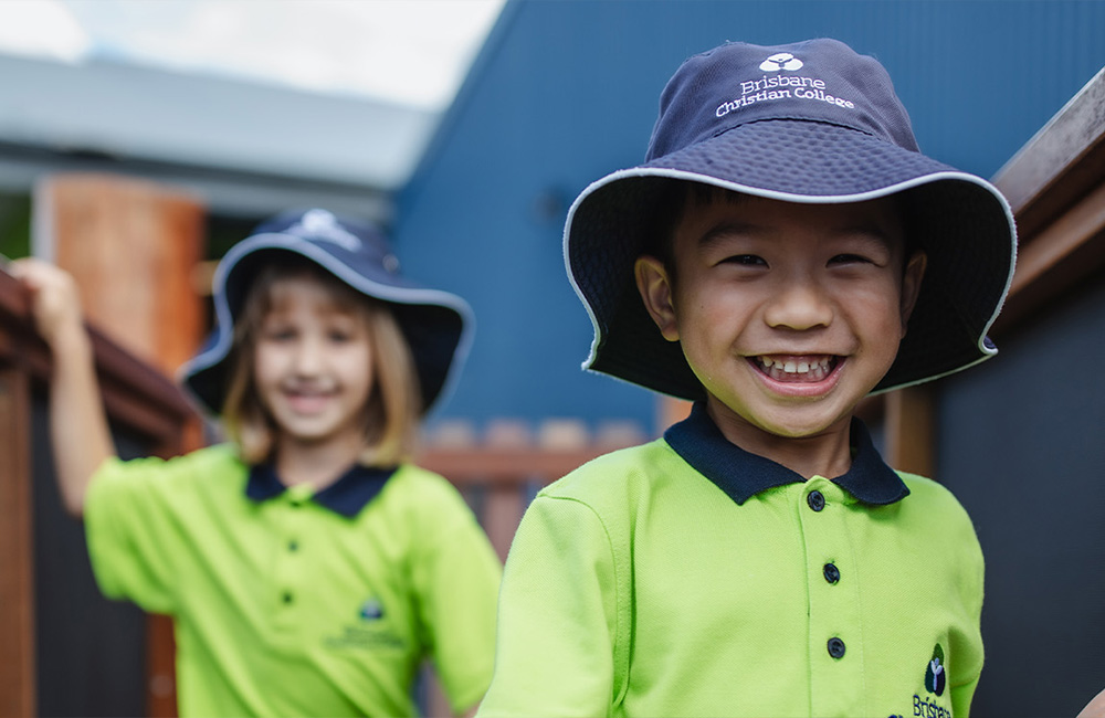 Two young girls wearing Prep uniform with outdoor hats